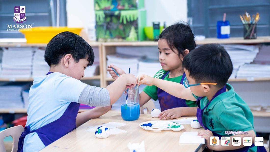 Primary students painting in art class