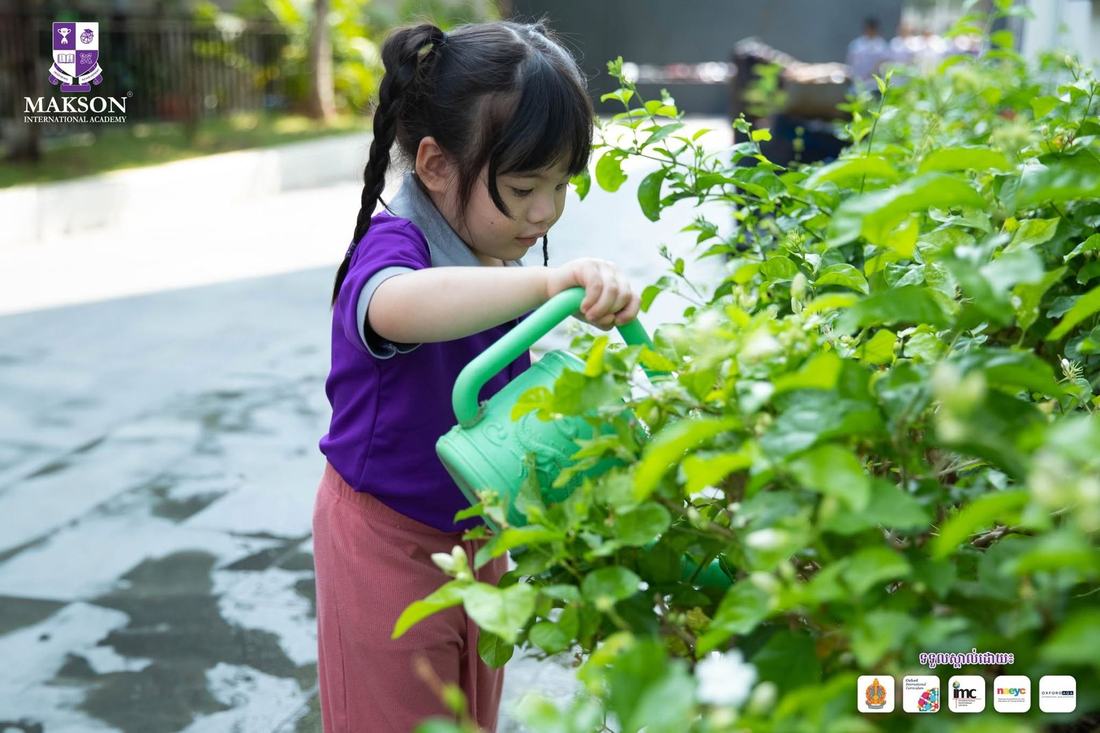 Child watering plants in the school garden