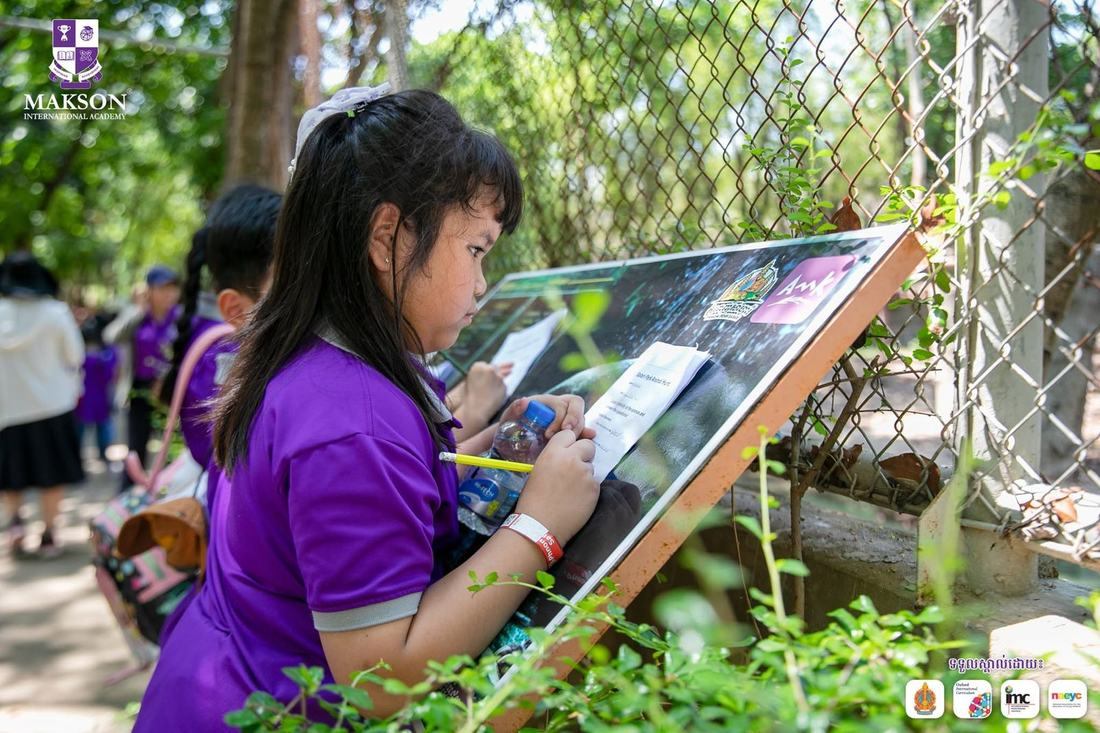 A student sketching and investigating outdoors