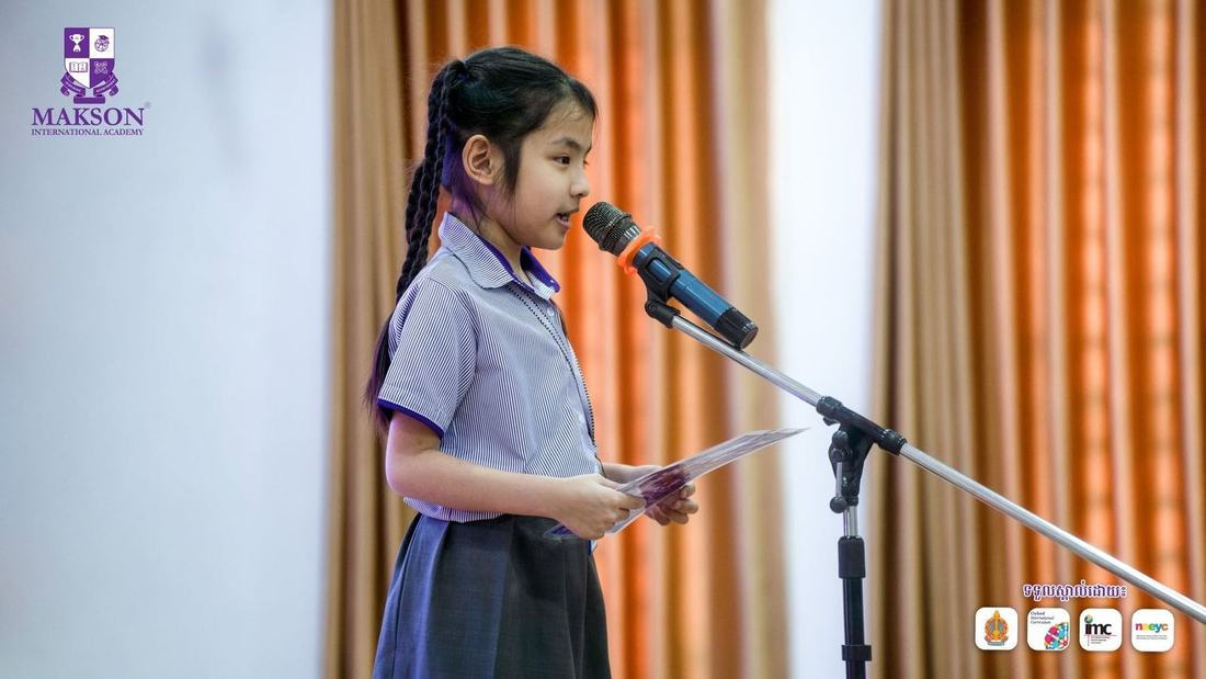 A MAKSON student speaking confidently at a microphone